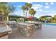Outdoor kitchen featuring stone counters, built-in grill, sink, pool, and outdoor play area at 2822 Ashby Ave, Las Vegas, NV 89102