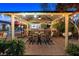 Inviting outdoor kitchen with stone countertops, bar seating, and stylish patio furniture under string lights at 2822 Ashby Ave, Las Vegas, NV 89102