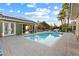 Outdoor pool area with bi-fold doors to game room, lounge chairs and spa at 2822 Ashby Ave, Las Vegas, NV 89102