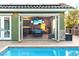 Poolside view of indoor/outdoor game room with bi-fold doors to the pool area and outdoor kitchen at 2822 Ashby Ave, Las Vegas, NV 89102