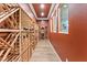 Long wine cellar featuring custom wood racks for wine storage and rustic orange walls and trim at 2822 Ashby Ave, Las Vegas, NV 89102