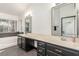 Bathroom featuring a soaking tub, large mirrors and double sinks with dark vanity and modern fixtures at 286 Fairmeadow St, Henderson, NV 89012