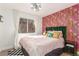 Eclectic bedroom with vibrant wallpaper, natural lighting and unique design elements at 286 Fairmeadow St, Henderson, NV 89012