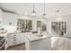 A modern kitchen with white cabinets, granite countertops, stainless steel appliances and tile flooring at 286 Fairmeadow St, Henderson, NV 89012