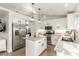 Modern kitchen with white cabinets, stainless steel appliances and granite countertops with a center island at 286 Fairmeadow St, Henderson, NV 89012