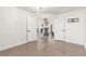 Bright, open-concept living space with elegant chandelier and tiled floors leading to an open living space at 286 Fairmeadow St, Henderson, NV 89012