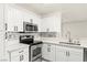 Bright kitchen featuring stainless steel appliances, white cabinetry and stone backsplash at 3150 Soft Breezes Dr # 1037, Las Vegas, NV 89128