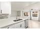 Bright kitchen with stainless steel sink, modern appliances, and views of the living space at 3150 Soft Breezes Dr # 1037, Las Vegas, NV 89128
