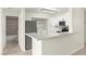 Open-concept kitchen featuring stainless steel appliances and bar-style counter seating at 3150 Soft Breezes Dr # 1037, Las Vegas, NV 89128