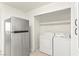 Convenient laundry area with washer, dryer, and a modern stainless steel refrigerator at 3150 Soft Breezes Dr # 1037, Las Vegas, NV 89128