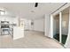 Open living area features a modern kitchen, and access to an outdoor patio through a sliding door at 3150 Soft Breezes Dr # 1037, Las Vegas, NV 89128