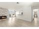Spacious living room featuring modern fireplace and light wood-look flooring at 3150 Soft Breezes Dr # 1037, Las Vegas, NV 89128