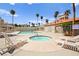 Community pool area featuring a pool, hot tub, lounge chairs, and shade structures at 3150 Soft Breezes Dr # 1037, Las Vegas, NV 89128
