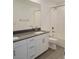A bathroom with double sinks with white cabinets, toilet and walk-in shower at 3210 Centano Ave, Henderson, NV 89044