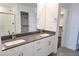 A modern bathroom featuring double sinks with white cabinets, walk-in shower and walk-in closet at 3210 Centano Ave, Henderson, NV 89044