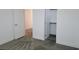 A bedroom with a closet, doorway to another room and gray carpet at 3210 Centano Ave, Henderson, NV 89044