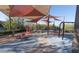 A modern playground with shade, a variety of climbing and sliding structures, and a safe, cushioned surface at 3210 Centano Ave, Henderson, NV 89044