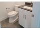 Powder room with a toilet, sink, and vanity with a gray countertop at 3210 Centano Ave, Henderson, NV 89044