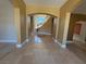 Inviting foyer with decorative tile inset and grand staircase, enhanced by abundant natural light at 357 Whispering Tree Ave, Las Vegas, NV 89183