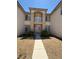 Elegant home entrance featuring a private balcony and manicured shrubs at 357 Whispering Tree Ave, Las Vegas, NV 89183