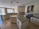 Gourmet kitchen with granite countertops, stainless steel appliances, and custom cabinetry at 357 Whispering Tree Ave, Las Vegas, NV 89183