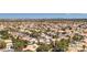 Wide aerial view of a residential community, combining tiled roofs and lush green landscapes at 3633 Fox Heather Dr, Las Vegas, NV 89129