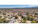 High-angle aerial shot of a densely populated neighborhood featuring tiled roofs and lush greenery at 3633 Fox Heather Dr, Las Vegas, NV 89129