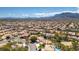 Expansive aerial view of a residential neighborhood with well-manicured lawns and mountain views at 3633 Fox Heather Dr, Las Vegas, NV 89129
