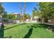 This backyard features a well-maintained lawn, pool, and mature landscaping at 3633 Fox Heather Dr, Las Vegas, NV 89129
