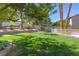 This backyard features a well-maintained lawn and mature landscaping at 3633 Fox Heather Dr, Las Vegas, NV 89129