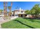 Home's backyard features large lawn, pool, and mature landscaping at 3633 Fox Heather Dr, Las Vegas, NV 89129