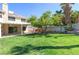 Expansive backyard with lush green lawn, covered patio, and outdoor grill, perfect for entertaining at 3633 Fox Heather Dr, Las Vegas, NV 89129