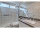 Modern bathroom with glass-enclosed shower, neutral tile, and a sleek vanity at 3633 Fox Heather Dr, Las Vegas, NV 89129