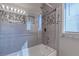 The bathroom features updated tiling, a shower head, and glass door at 3633 Fox Heather Dr, Las Vegas, NV 89129