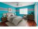 Bright bedroom with hardwood floors, a ceiling fan, and modern decor at 3633 Fox Heather Dr, Las Vegas, NV 89129