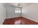 Bedroom features hardwood floors, a closet, ceiling fan, and arched window at 3633 Fox Heather Dr, Las Vegas, NV 89129
