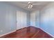 This bedroom has cherry wood floors, a ceiling fan, and a closet at 3633 Fox Heather Dr, Las Vegas, NV 89129