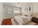 Cozy bedroom with hardwood floors, a ceiling fan, and ample natural light at 3633 Fox Heather Dr, Las Vegas, NV 89129