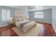 Comfortable bedroom features hardwood floors, natural light, and neutral décor at 3633 Fox Heather Dr, Las Vegas, NV 89129