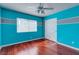 Bright bedroom has laminate floors, striped accent wall, and closet at 3633 Fox Heather Dr, Las Vegas, NV 89129