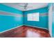 Bright bedroom has laminate floors, striped accent wall, and closet at 3633 Fox Heather Dr, Las Vegas, NV 89129