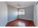 Bedroom with hardwood floors, plantation shutters, light blue walls, and white trim at 3633 Fox Heather Dr, Las Vegas, NV 89129