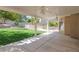 Inviting covered patio overlooking a green lawn and a fenced swimming pool at 3633 Fox Heather Dr, Las Vegas, NV 89129
