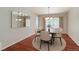 Comfortable dining room with hardwood floors, modern lighting, and seating for six at 3633 Fox Heather Dr, Las Vegas, NV 89129