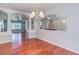 Open-concept dining room with hardwood floors, adjacent to living room at 3633 Fox Heather Dr, Las Vegas, NV 89129