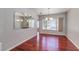 Hardwood-floored dining room with modern lighting and backyard views at 3633 Fox Heather Dr, Las Vegas, NV 89129