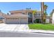 Spacious two-story home showcasing a three-car garage, mature landscaping and a tile roof at 3633 Fox Heather Dr, Las Vegas, NV 89129