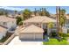 Aerial view of a beautiful two-story home with a tile roof and well-manicured lawn at 3633 Fox Heather Dr, Las Vegas, NV 89129