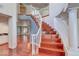 Stunning foyer featuring a winding staircase, hardwood floors, and an open view into the living spaces at 3633 Fox Heather Dr, Las Vegas, NV 89129