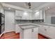 Well-lit kitchen featuring white cabinets, a central island, and modern appliances at 3633 Fox Heather Dr, Las Vegas, NV 89129